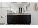 Modern bathroom features double vanity with granite countertop, black cabinets, and a sleek, glass-enclosed shower at 2668 Scoter Ln, Castle Rock, CO 80104