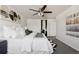 Spacious bedroom featuring a large bed, ceiling fan, and stylish decor at 2668 Scoter Ln, Castle Rock, CO 80104