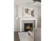 Fireplace with an elegant white mantel and decorative artwork above at 2668 Scoter Ln, Castle Rock, CO 80104
