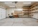 Spacious garage with workbench, storage shelves, and ample room for parking and projects at 2668 Scoter Ln, Castle Rock, CO 80104