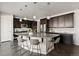 Modern kitchen featuring an island with seating and dark cabinets at 2668 Scoter Ln, Castle Rock, CO 80104