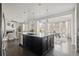 Open concept kitchen with island, seamlessly connecting to the living and dining areas in a bright open space at 2668 Scoter Ln, Castle Rock, CO 80104