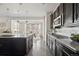 Modern kitchen view flows into bright eating area with large windows and dark cabinets at 2668 Scoter Ln, Castle Rock, CO 80104