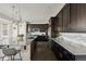 Spacious kitchen featuring dark cabinetry, stainless steel appliances, and a large island at 2668 Scoter Ln, Castle Rock, CO 80104