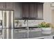 Close up of a modern kitchen with stainless steel appliances, granite countertops and dark cabinetry at 2668 Scoter Ln, Castle Rock, CO 80104