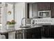 Stylish kitchen island with granite countertops and stainless steel sink at 2668 Scoter Ln, Castle Rock, CO 80104