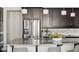 Bright kitchen boasts stainless steel appliances, granite countertops, and pendant lighting above a large island at 2668 Scoter Ln, Castle Rock, CO 80104
