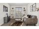 Nicely appointed living room with gray couch, accent rug, stylish decor, shelving and eating area at 2668 Scoter Ln, Castle Rock, CO 80104