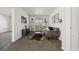 Cozy living room with gray couch, accent rug, stylish decor, and shelving flanking a window at 2668 Scoter Ln, Castle Rock, CO 80104
