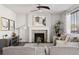 Bright living room features a cozy fireplace, modern decor, and ample seating for comfortable gatherings at 2668 Scoter Ln, Castle Rock, CO 80104