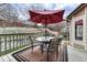 Back deck with outdoor seating, table, grill, and a red umbrella at 7114 Mountain Brush Cir, Highlands Ranch, CO 80130