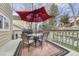 Back deck with outdoor seating, table, grill, and a red umbrella at 7114 Mountain Brush Cir, Highlands Ranch, CO 80130