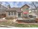 Backyard view featuring a wooden deck with outdoor seating, lovely stone landscaping, and mature trees at 7114 Mountain Brush Cir, Highlands Ranch, CO 80130