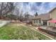 Lovely backyard featuring a wood fence, tiered garden, and a deck perfect for outdoor entertaining at 7114 Mountain Brush Cir, Highlands Ranch, CO 80130