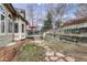Backyard featuring a deck, stone walkway, and tiered landscaping at 7114 Mountain Brush Cir, Highlands Ranch, CO 80130