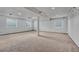 Finished basement with carpet, neutral paint, and natural light from above-ground windows at 7114 Mountain Brush Cir, Highlands Ranch, CO 80130