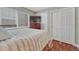 Comfortable bedroom featuring a plush bed, hardwood floors, and closet doors at 7114 Mountain Brush Cir, Highlands Ranch, CO 80130