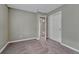 Neutral bedroom with gray walls, carpet, closet, and view into other rooms at 7114 Mountain Brush Cir, Highlands Ranch, CO 80130