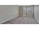 Neutral bedroom featuring carpeted floors, two windows, and a minimalist design at 7114 Mountain Brush Cir, Highlands Ranch, CO 80130