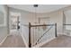 Upstairs hall showcases a chandelier, decorative rug, and opens to bedroom at 7114 Mountain Brush Cir, Highlands Ranch, CO 80130