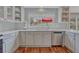 Bright kitchen featuring stainless steel appliances, white cabinets, and view to backyard at 7114 Mountain Brush Cir, Highlands Ranch, CO 80130