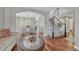 Open concept living and dining area featuring hardwood floors and staircase at 7114 Mountain Brush Cir, Highlands Ranch, CO 80130