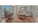 Cozy living room with hardwood floors, a large window, and comfortable seating arrangements at 7114 Mountain Brush Cir, Highlands Ranch, CO 80130