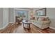 Comfortable living room featuring hardwood floors and natural light from the window at 7114 Mountain Brush Cir, Highlands Ranch, CO 80130