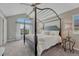 Main bedroom with a four-poster bed, large window, and tasteful décor at 7114 Mountain Brush Cir, Highlands Ranch, CO 80130