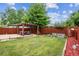 Backyard featuring a pergola with outdoor seating, garden beds, and a lush lawn, perfect for relaxation and entertainment at 11855 Humboldt Dr, Northglenn, CO 80233