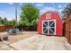 Barn-style shed with a rustic design in a spacious backyard, complete with outdoor seating and patio area at 11855 Humboldt Dr, Northglenn, CO 80233