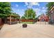 Backyard featuring a pergola with outdoor seating, a fire pit area, and a barn-style shed with a rustic design at 11855 Humboldt Dr, Northglenn, CO 80233