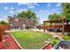 Backyard featuring a patio, pergola with outdoor seating, a fire pit area, and a well-maintained grassy area at 11855 Humboldt Dr, Northglenn, CO 80233