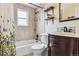 Bathroom with a bathtub, tiled walls, and a vanity at 11855 Humboldt Dr, Northglenn, CO 80233