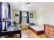 Bedroom with hardwood floors, window, and desk setup at 11855 Humboldt Dr, Northglenn, CO 80233