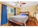 Bright bedroom with a ceiling fan, blue curtains, and hardwood floors at 11855 Humboldt Dr, Northglenn, CO 80233