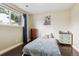 Cozy bedroom with a window, dark wood flooring, and light-colored walls at 11855 Humboldt Dr, Northglenn, CO 80233
