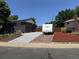 Home exterior view with a brick driveway, landscaped yard, and a recreational vehicle at 11855 Humboldt Dr, Northglenn, CO 80233