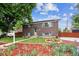Lovely brick home featuring a well-manicured lawn, vibrant flowerbeds and inviting curb appeal at 11855 Humboldt Dr, Northglenn, CO 80233