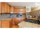 Stylish kitchen features granite counters, tile backsplash and stainless steel appliances, creating a great space at 11855 Humboldt Dr, Northglenn, CO 80233