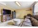 Spacious living room with fireplace, television, and leather furniture at 11855 Humboldt Dr, Northglenn, CO 80233