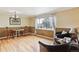 Cozy living area featuring hardwood floors, natural light, and comfortable seating arrangement at 11855 Humboldt Dr, Northglenn, CO 80233