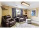 Living room with a leather couch, recliner, and ottoman at 11855 Humboldt Dr, Northglenn, CO 80233