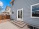 Back exterior of the home features a private patio and a well-maintained gray exterior at 306 Monares Ln, Erie, CO 80516