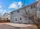 Backyard featuring a gray home, a stone patio, and well-manicured landscaping at 306 Monares Ln, Erie, CO 80516