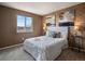 A charming bedroom showcasing exposed brick, natural light, and stylish decor at 306 Monares Ln, Erie, CO 80516