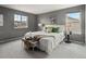 A serene bedroom offering a luxurious bed, stylish decor, and plenty of natural light at 306 Monares Ln, Erie, CO 80516