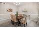 Bright dining room featuring a wooden table with tufted chairs and modern decor creating an inviting atmosphere at 306 Monares Ln, Erie, CO 80516