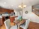 Cozy dining area features a rustic wood table, stylish chandelier, and hardwood floors at 306 Monares Ln, Erie, CO 80516