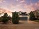 Charming two-story home features a gray exterior, an attached two-car garage, and a beautifully landscaped front yard at 306 Monares Ln, Erie, CO 80516